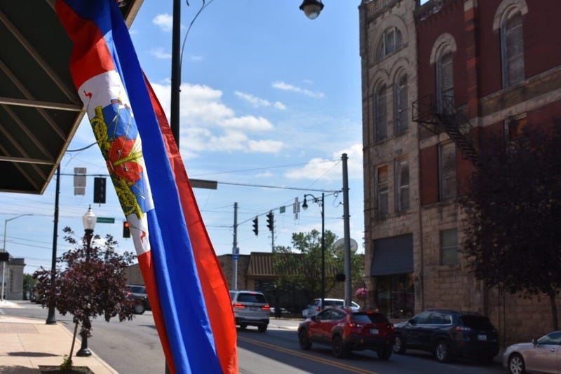 A Haitian flag hangs in front of a store in Logansport, Indiana, on July 7, 2026. (Photo by Jack Forrest/Indiana Capital Chronicle)
