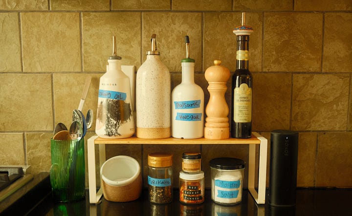 Kitchen stove and jars on a small shelf.