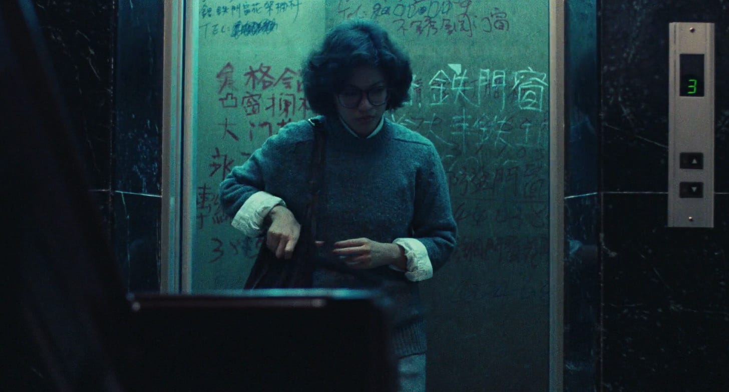 Ah-chen steps out of an elevator covered with graffiti in a still from Edward Yang's movie Taipei Story.