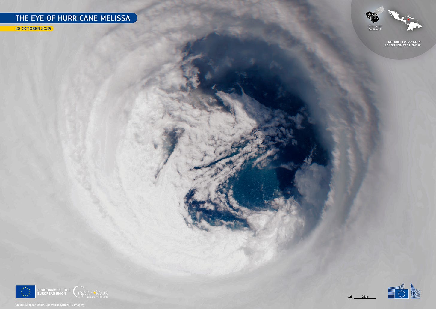 A photo of a hurricane from space, showing spots of blue ocean beneath heavily swirling white clouds