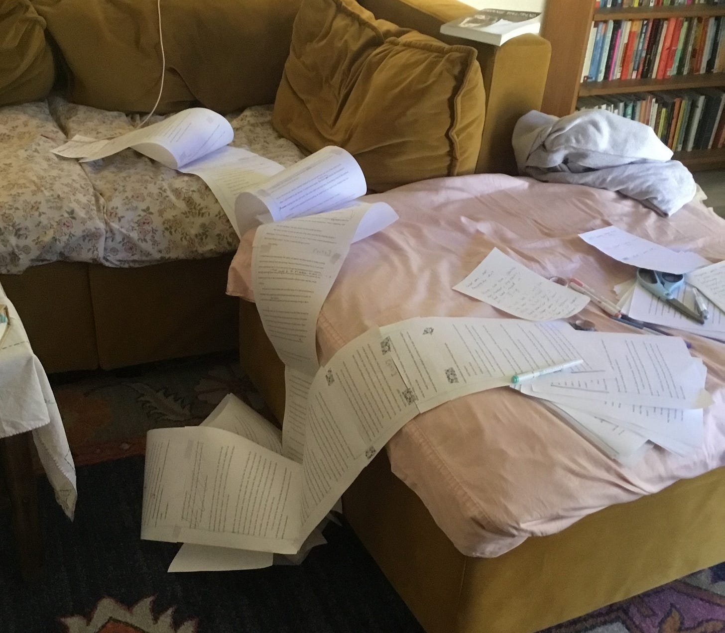 The scroll spreading across a copper-colored couch and footrest. 