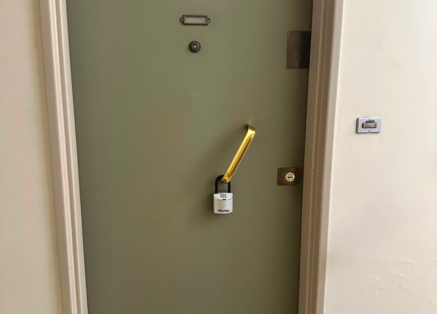 Key lockbox on an apartment door in Villefranche-sur-Mer, the kind that replaces a year-round neighbor with a two-week guest Key lockbox on an apartment door in Villefranche-sur-Mer, the kind that replaces a year-round neighbor with a two-week guest