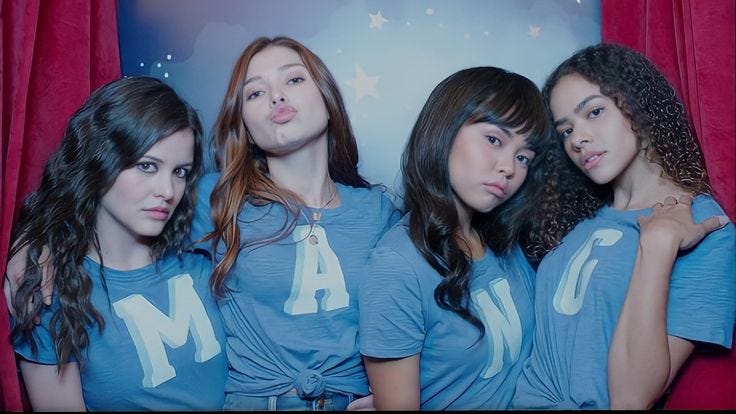 This may contain: three girls in blue shirts standing next to each other