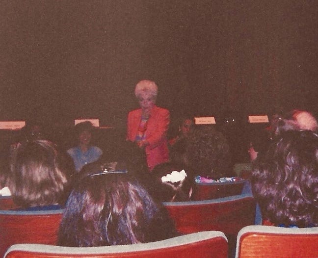 A person speaking to a group of people

Description automatically generated