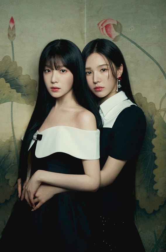 Red Velvet members Irene and Wendy dressed in black framed for a traditional portrait.