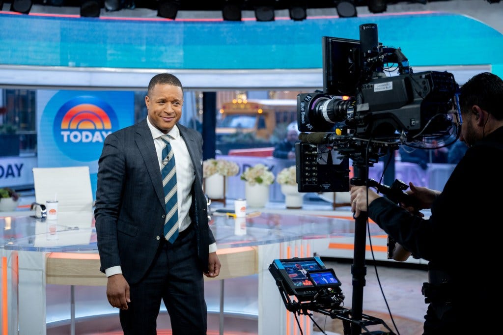 Craig Melvin filming for the Today Show, with a camera operator in the foreground. Craig Melvin filming for the Today Show, with a camera operator in the foreground.