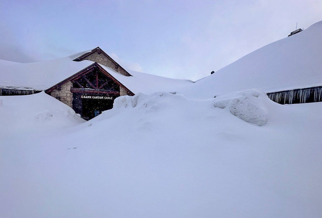 The Grand Canyon Lodge is barely visible under a piling of snowdrifts