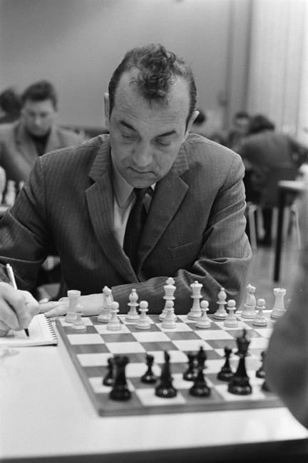 May be an image of 2 people and chess