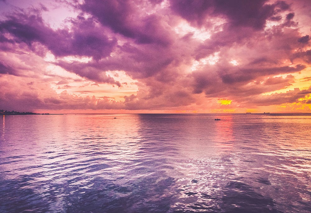 Purple and orange sunset over calm water