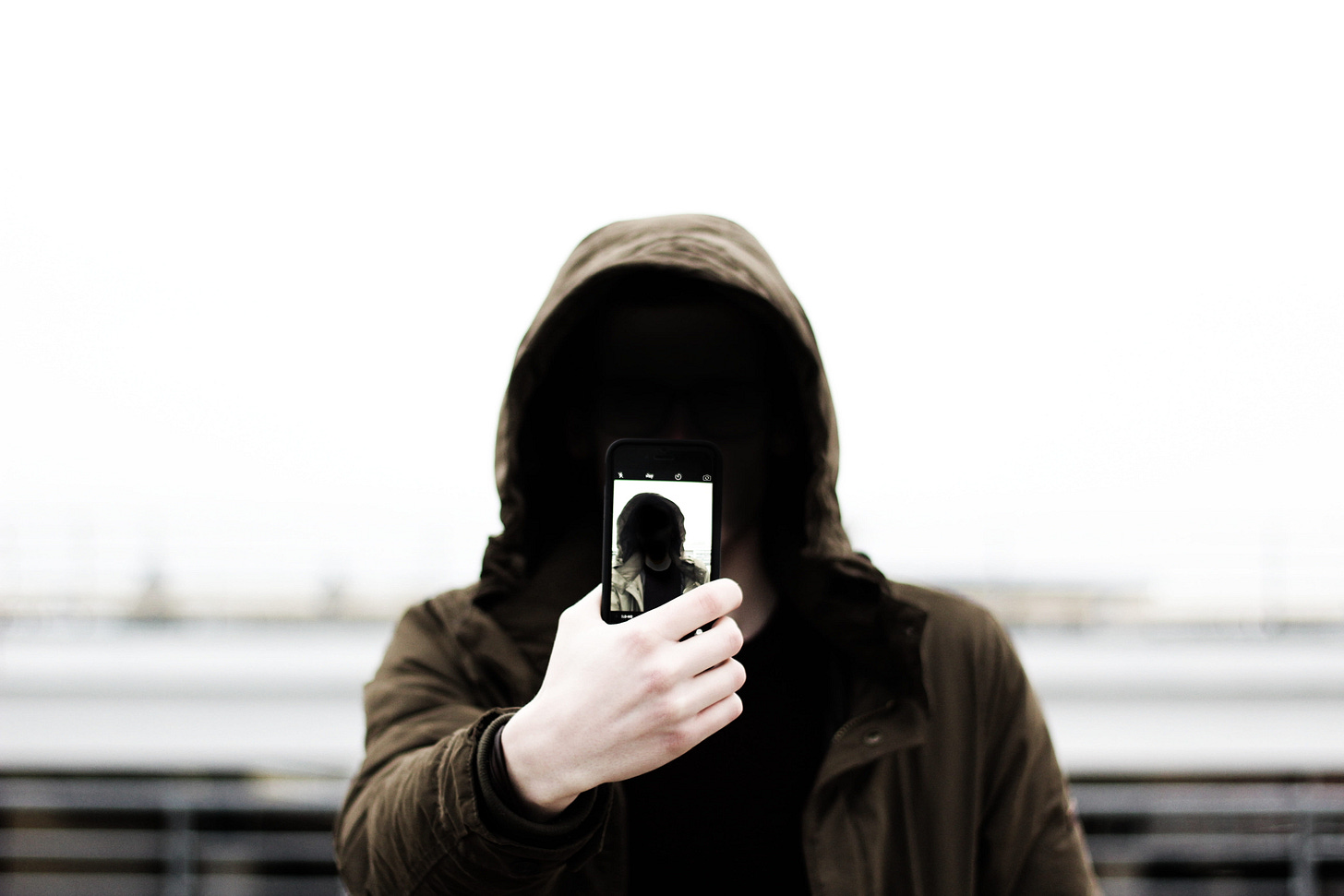 Person in a hoodie looking at a phone