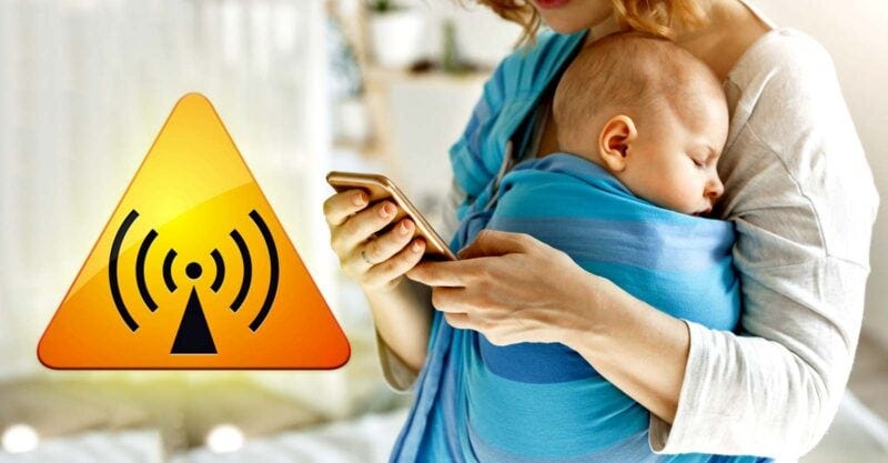 mom holding baby and cellphone