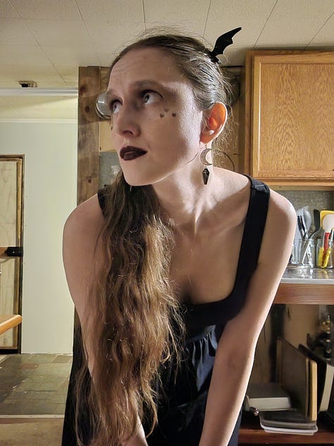 Goth Barbie look; witch-adjacent hat + red lip + celestial dress look; Bat-inspired look that ended up sort of Maleficent-y
