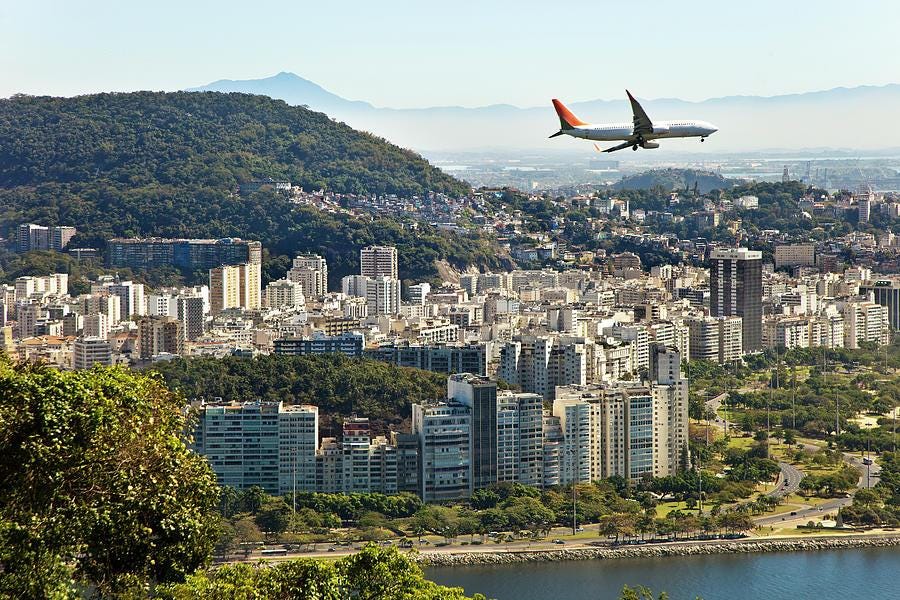 An airplane flying over a city

Description automatically generated