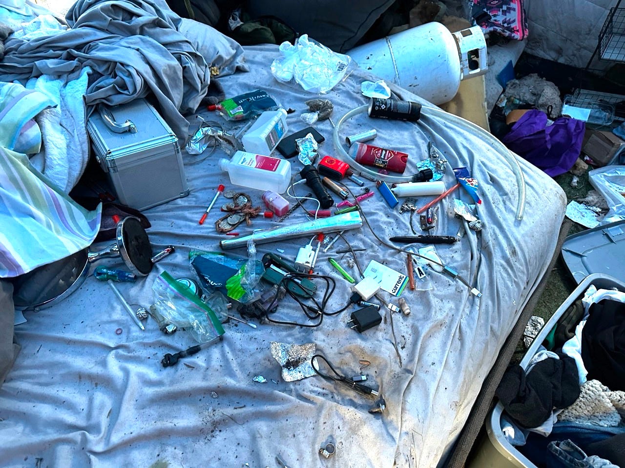 A pile of objects on a bed

Description automatically generated