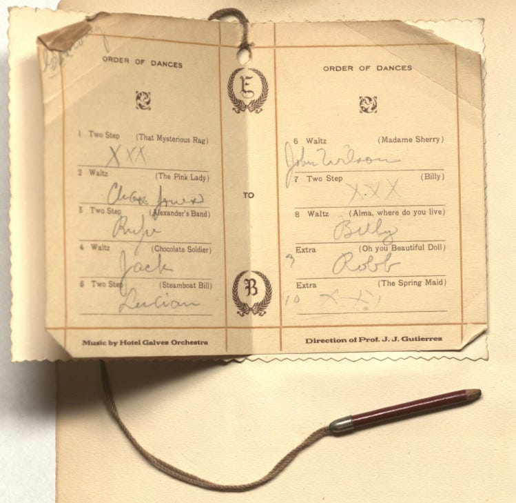 a paper booklet with the names of songs/dances typed and handwritten names or 'x's below. There is a pencil attached to the booklet by a string