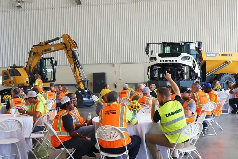Customers enjoying a barbecue lunch at the Liebherr Equipment Source open house event at the Liebherr USA, Co. Newport News, VA campus. Liebherr crawler excavator and articulated dump truck shown in the background. Customers enjoying a barbecue lunch at the Liebherr Equipment Source open house event at the Liebherr USA, Co. Newport News, VA campus. Liebherr crawler excavator and articulated dump truck shown in the background.