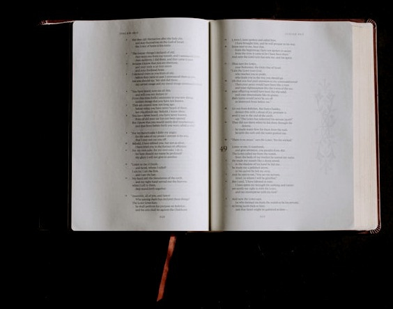 an open book sitting on top of a table an open book sitting on top of a table