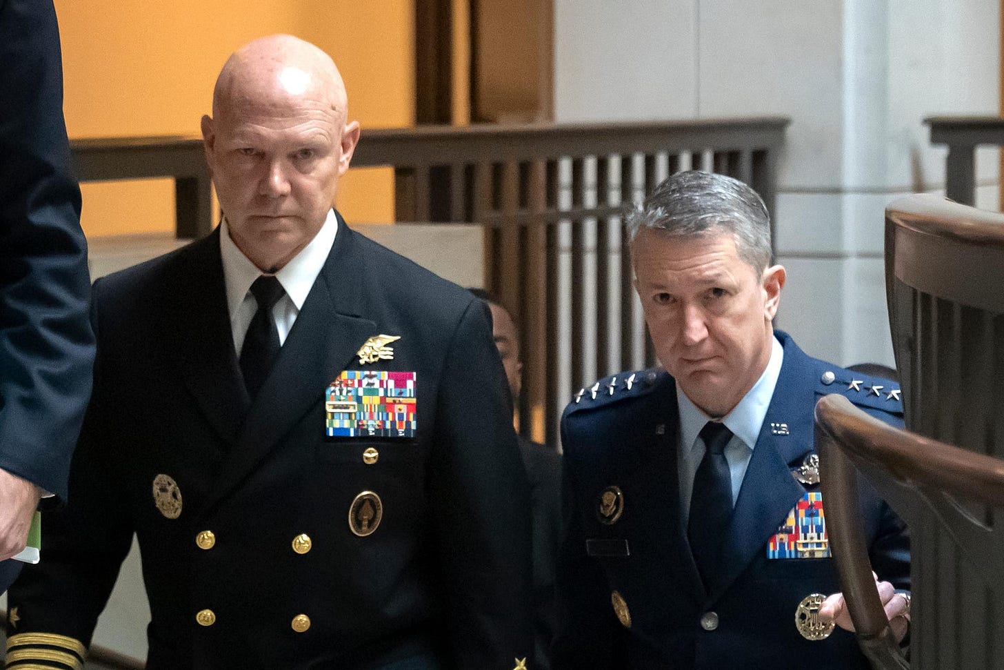 U.S. Navy Adm. Frank M. Bradley, accompanied by Gen. Dan Caine, chairman of the Joint Chiefs of Staff, right, walks to a meeting with senators on Capitol Hill on Thursday. (AP Photo/Mark Schiefelbein)