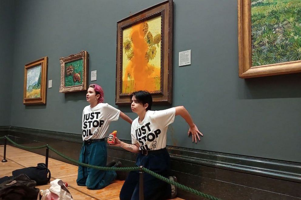 PHOTO: The Just Stop Oil climate campaign group shows activists with their hands glued to the wall under Vincent van Gogh's "Sunflowers" after throwing tomato soup on the painting at the National Gallery in central London on Oct. 14, 2022. PHOTO: The Just Stop Oil climate campaign group shows activists with their hands glued to the wall under Vincent van Gogh's "Sunflowers" after throwing tomato soup on the painting at the National Gallery in central London on Oct. 14, 2022.