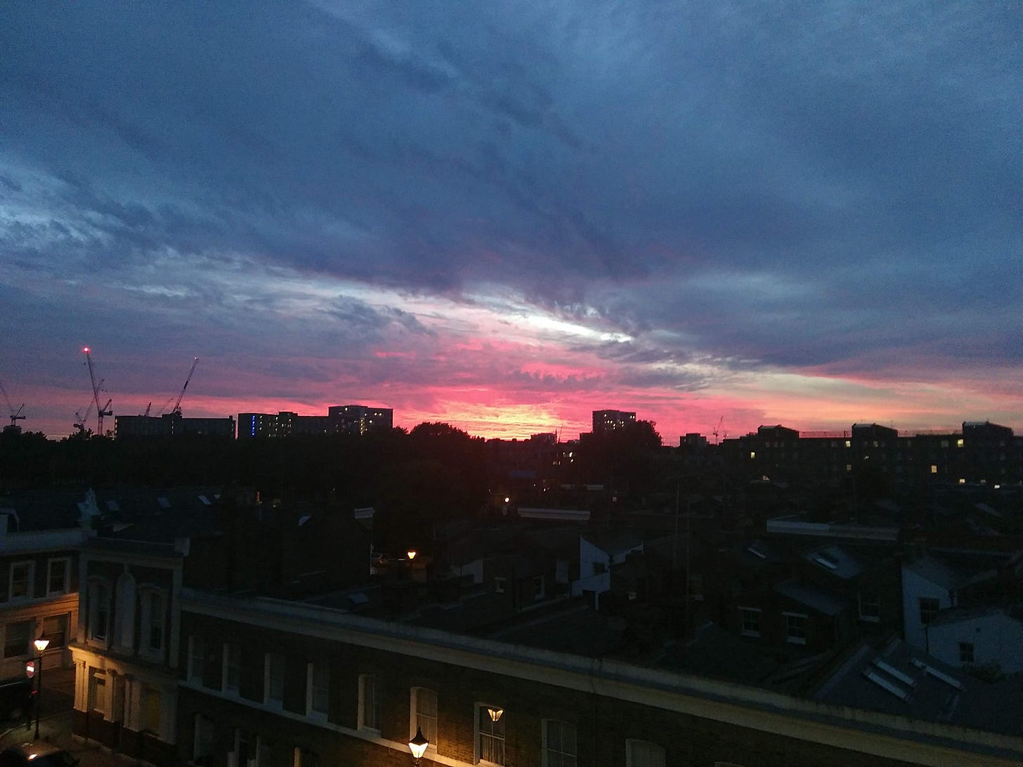 A picture of a sunset over a city horizon