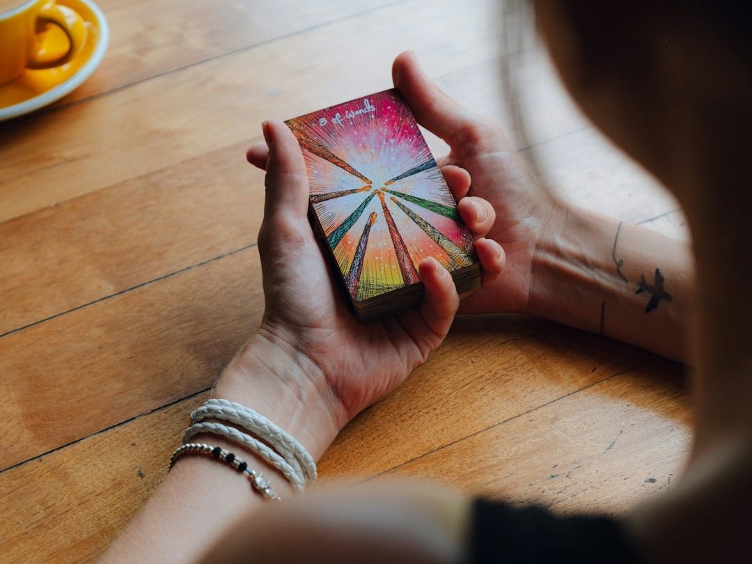 a woman sitting at a table holding a card