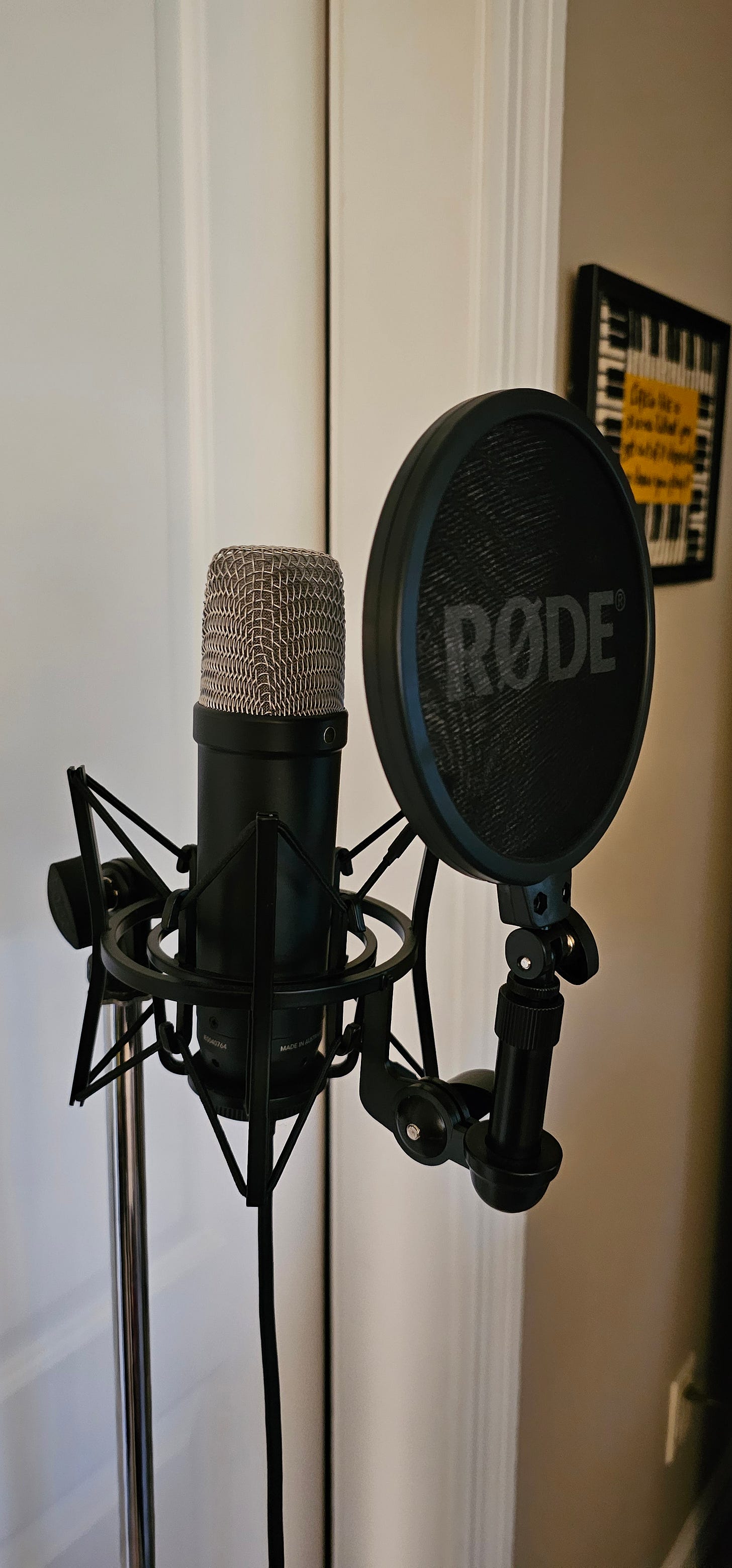 Photo of a microphone in an elaborate shock mount. Photo of a microphone in an elaborate shock mount.