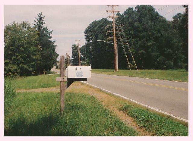 This may contain: a mailbox sitting on the side of a road