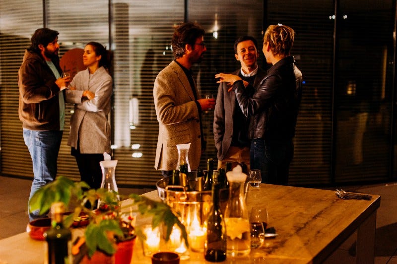 A group of people chatting around the table