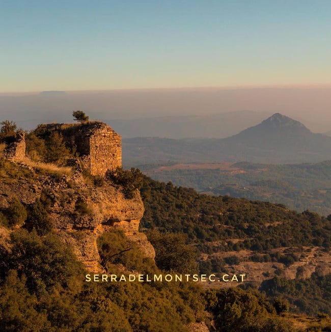 Impressionants vistes de La Noguera des del despoblat de Montadó. A la dreta, l'ermita romànica de Santa Anna (dalt d'un espadat impossible) i al fons la piràmide sagrada de Montmagastre. Montsec de Rúbies (o de Meià), Isona i Conca Dellà, Pallars Jussà. Lleida, Catalunya.