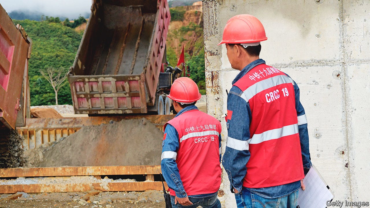 Men work with trucks at the Mirador mine of Ecuadorian Ecuacorriente, subsidiary of China's CRCC-Tongguan consortium, in Tundayme, Zamora Chinchipe in southeastern Ecuador on July 18, 2019, during the beginning of operations of Ecuador's largest copper mine. (Photo by Rodrigo BUENDIA / AFP) (Photo credit should read RODRIGO BUENDIA/AFP via Getty Images)