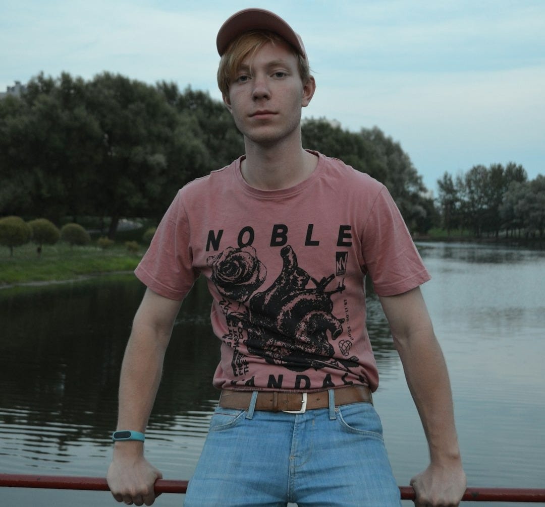 man in peach and black noble crew-neck t-shirt