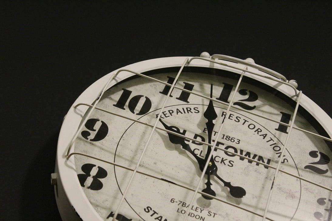 Image of a clock showing two minutes before 10. The label on it says “Old Town Clocks, repairs and restoration.”