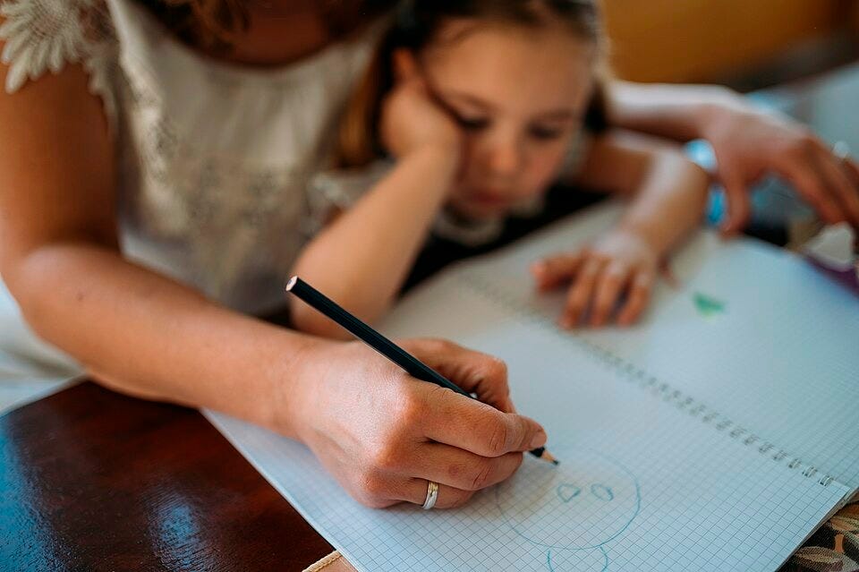 File:Child engaged in drawing activity with adult guidance indoors during daytime at home - Flickr - nenad53.jpg