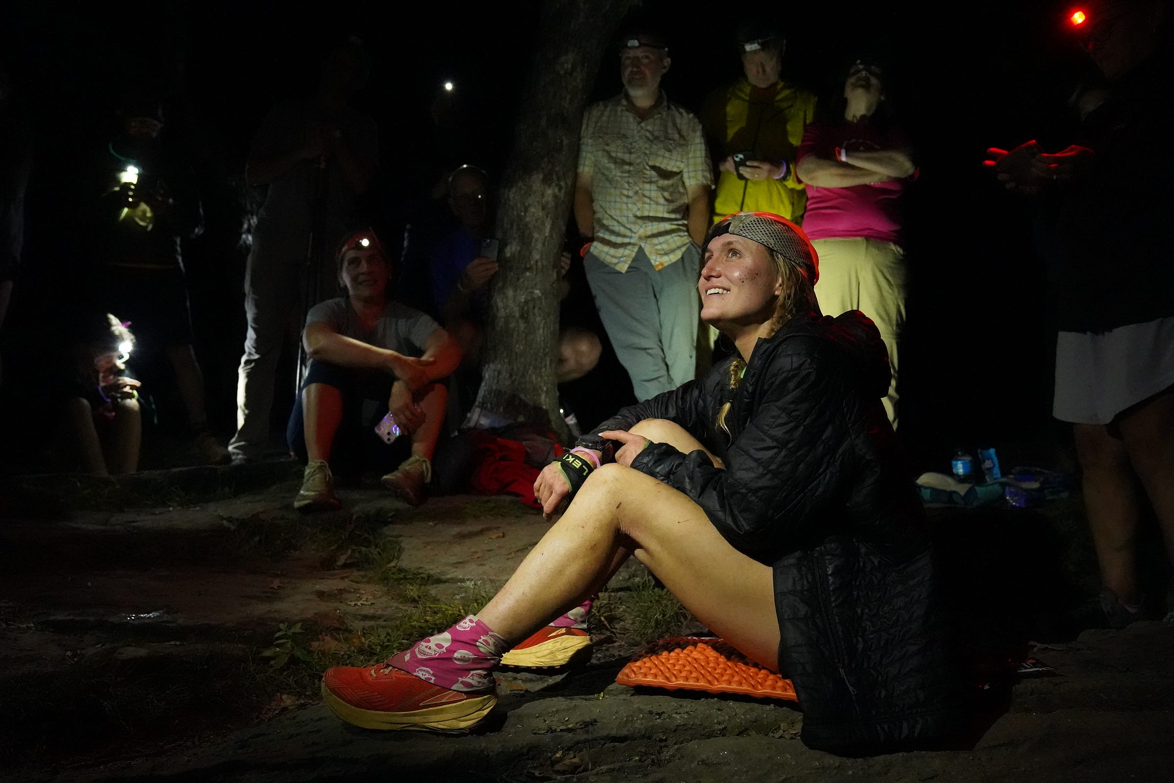 Tara Dower sitting on mountain surrounded by people Tara Dower sitting on mountain surrounded by people