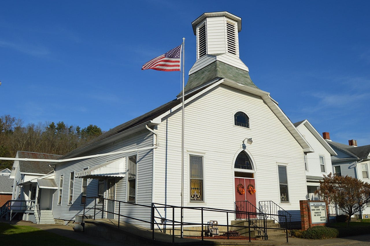 Church with U.S. flag flying in front of it. Church with U.S. flag flying in front of it.