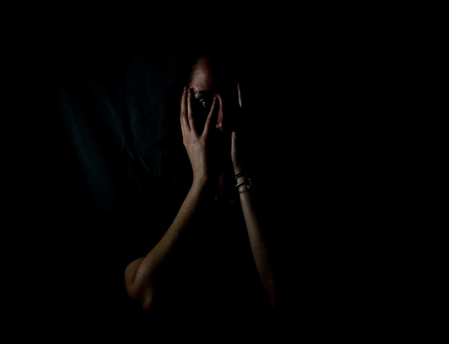 Liminal space: surreal distorted image of person in darkness