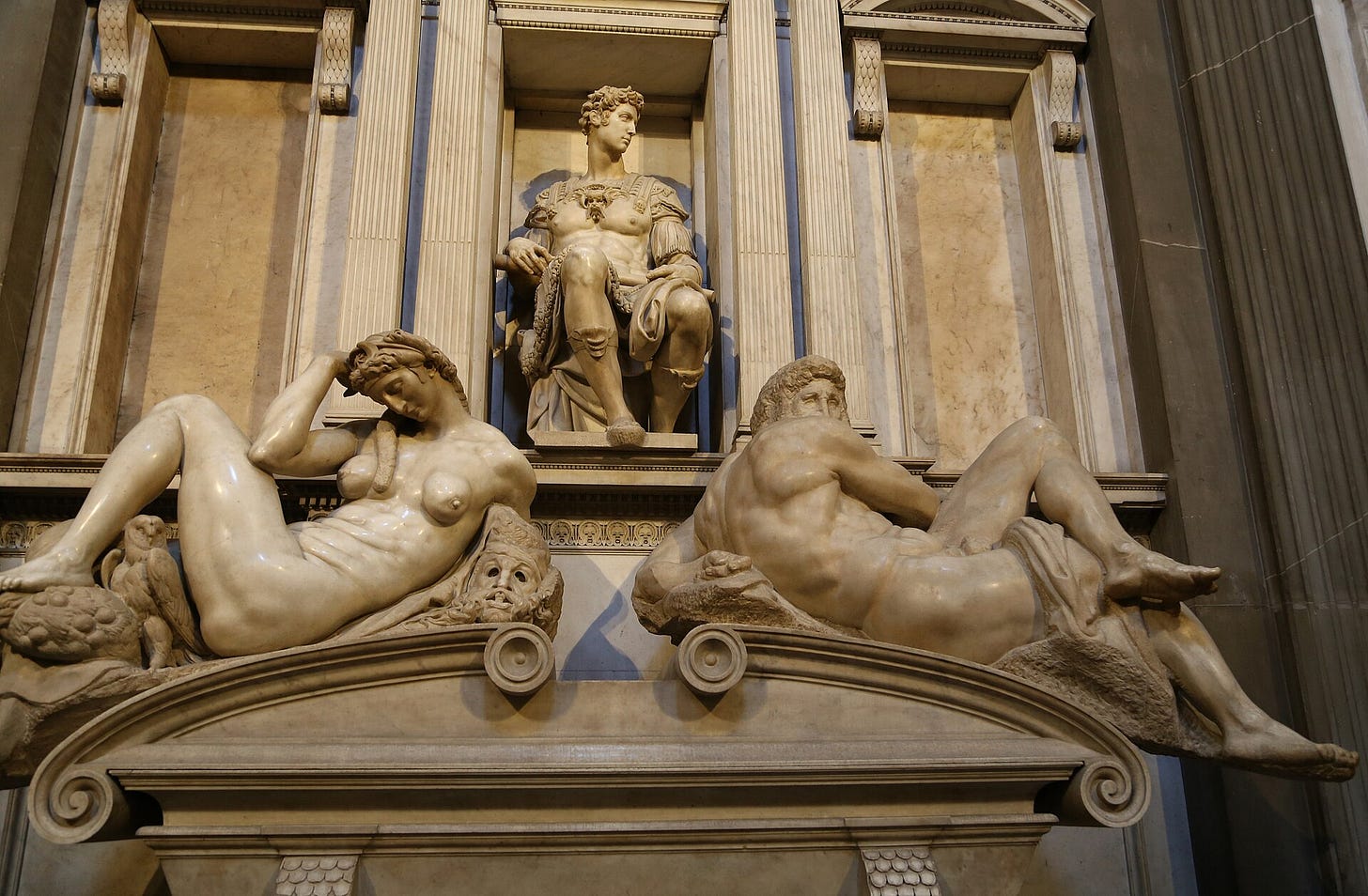 The tomb of Giuliano de' Medici, Michelangelo, Medici Chapel, Florence. "Night" on the left, "Day" on the right. The tomb of Giuliano de' Medici, Michelangelo, Medici Chapel, Florence. "Night" on the left, "Day" on the right.