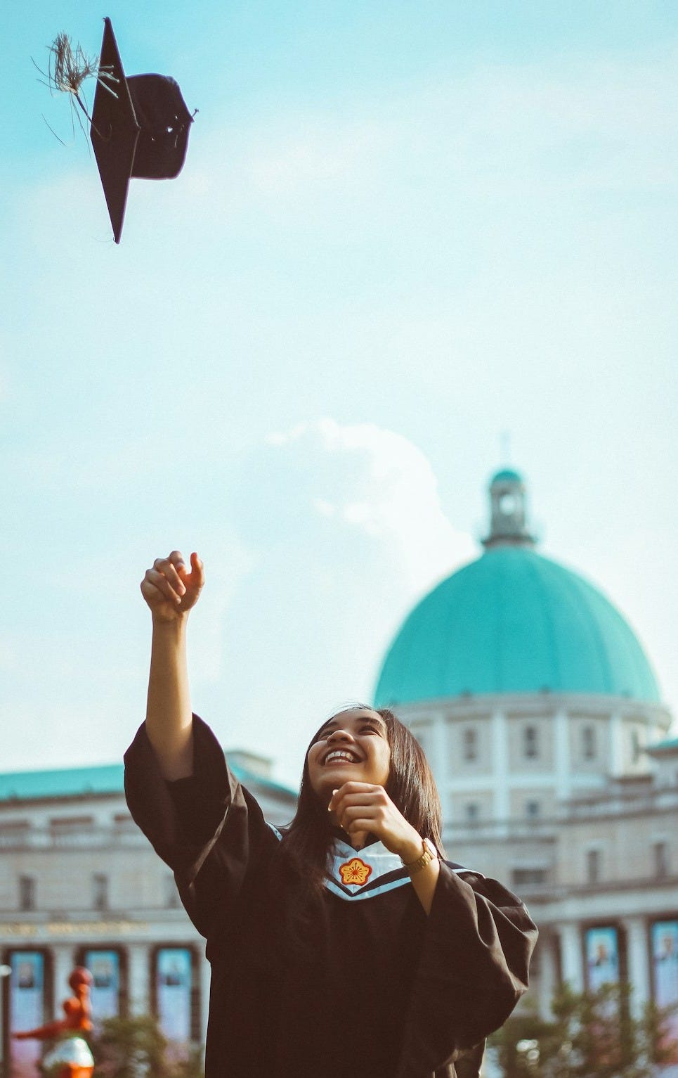 woman throwing her academic hat woman throwing her academic hat