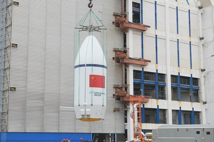 The Long March 6A's first-stage heading to the launch pad (left) and fairing being lifted atop of the launch vehicle (right).