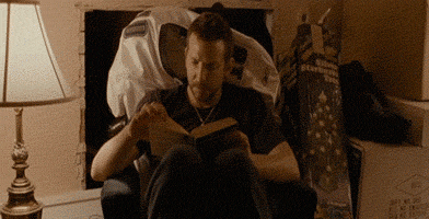 gif of man throwing book outside window