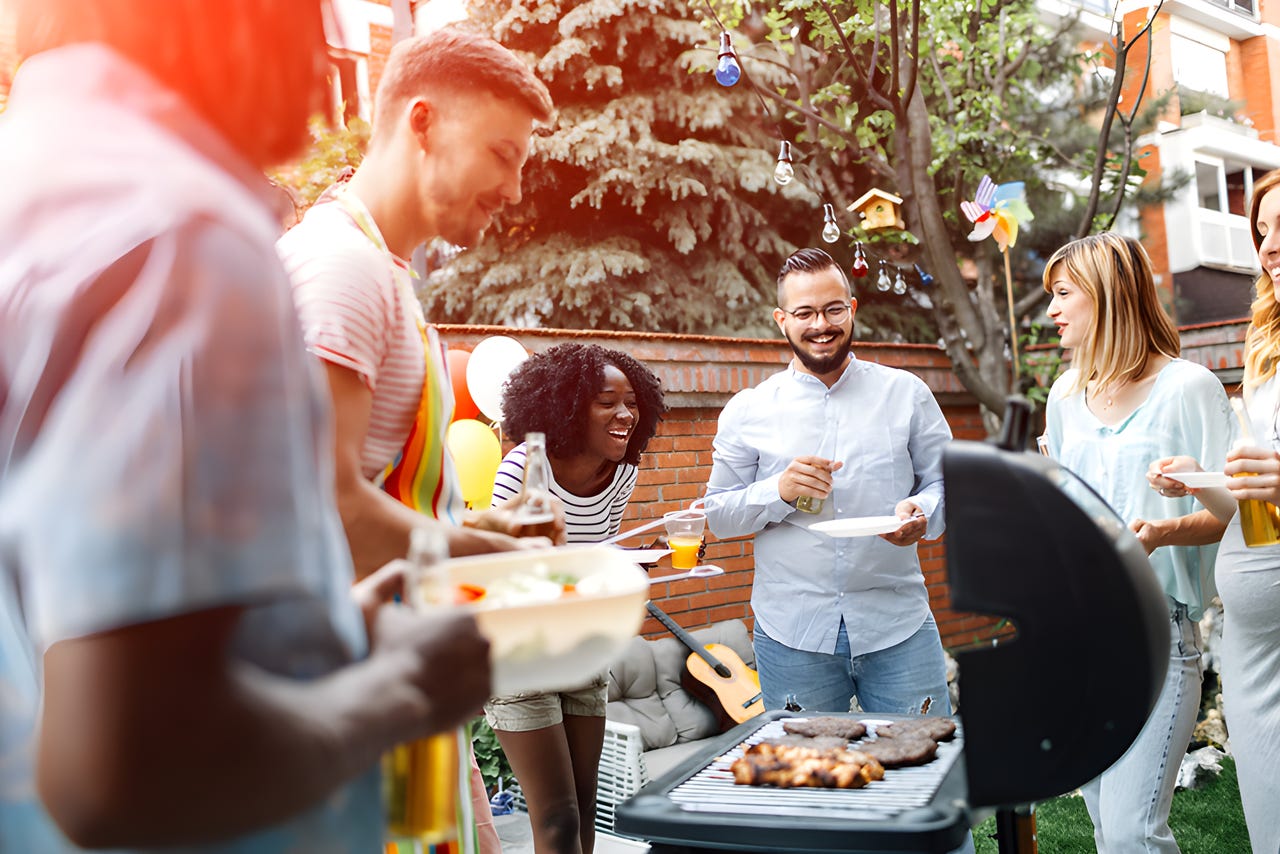 Group of friends gathered around a grill
