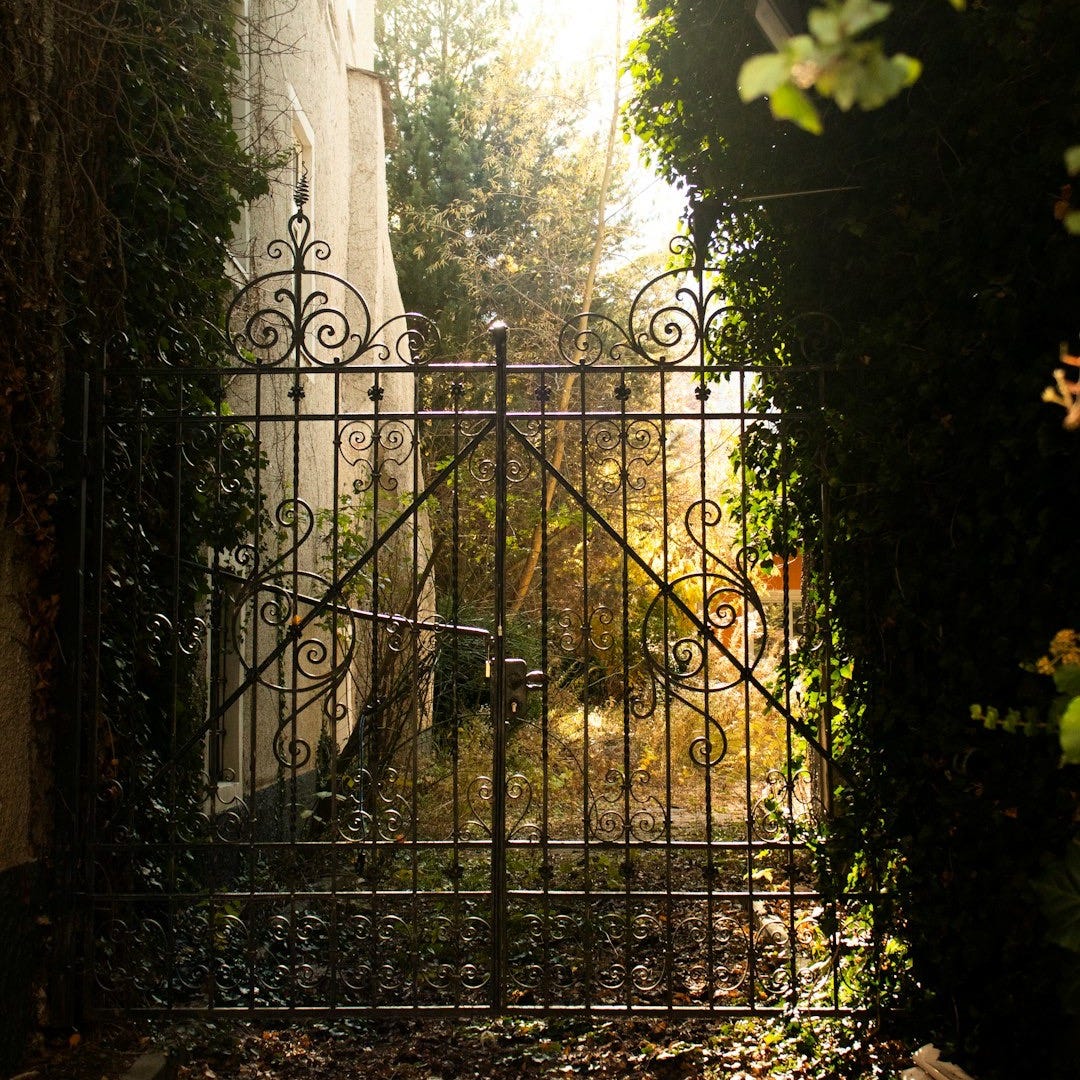 a gate that is open to a garden