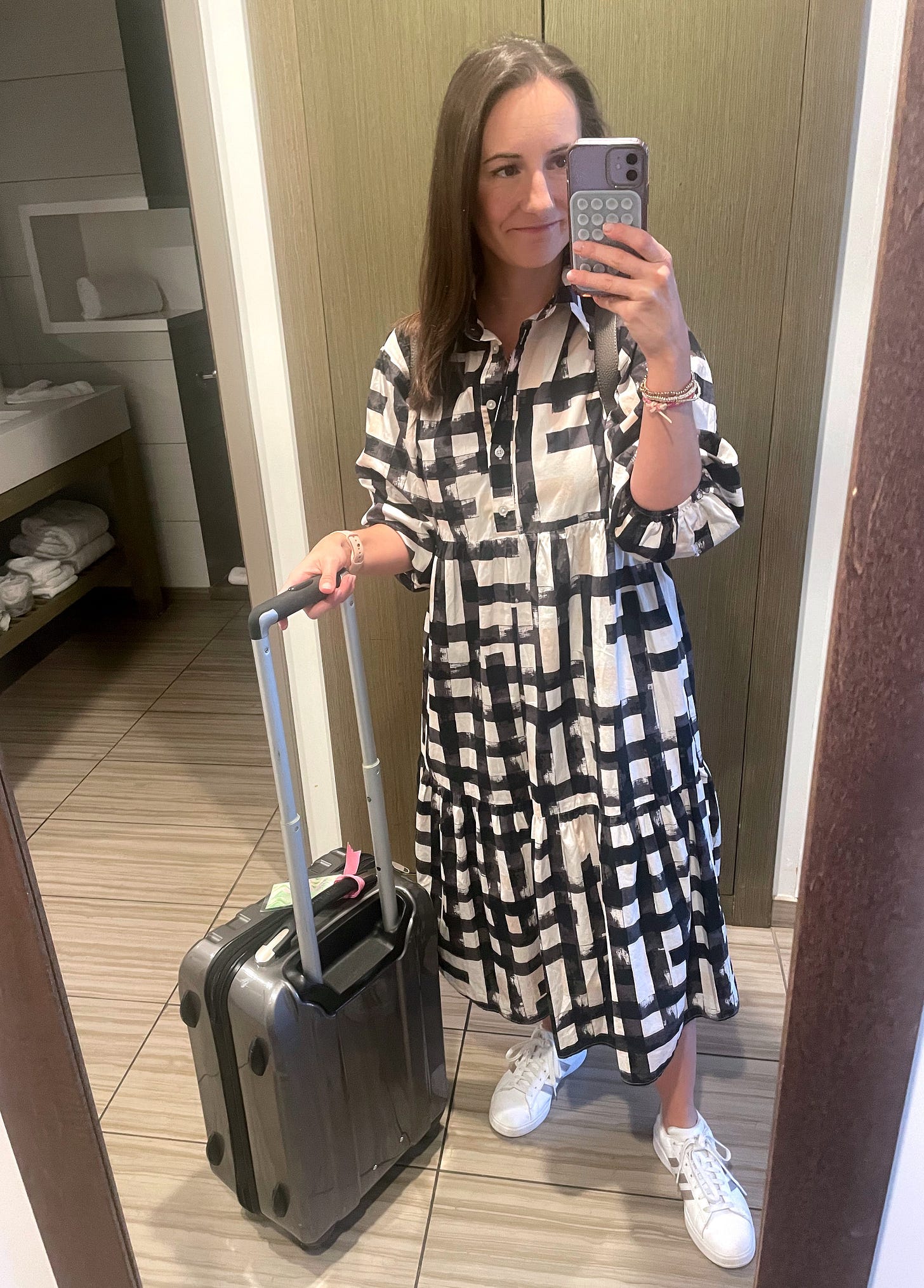 a woman taking a selfie with a suitcase a woman taking a selfie with a suitcase