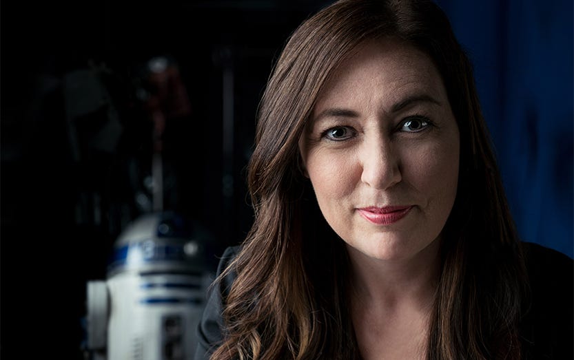 Lynwen Brennan's headshot. R2-D2 is in the background.