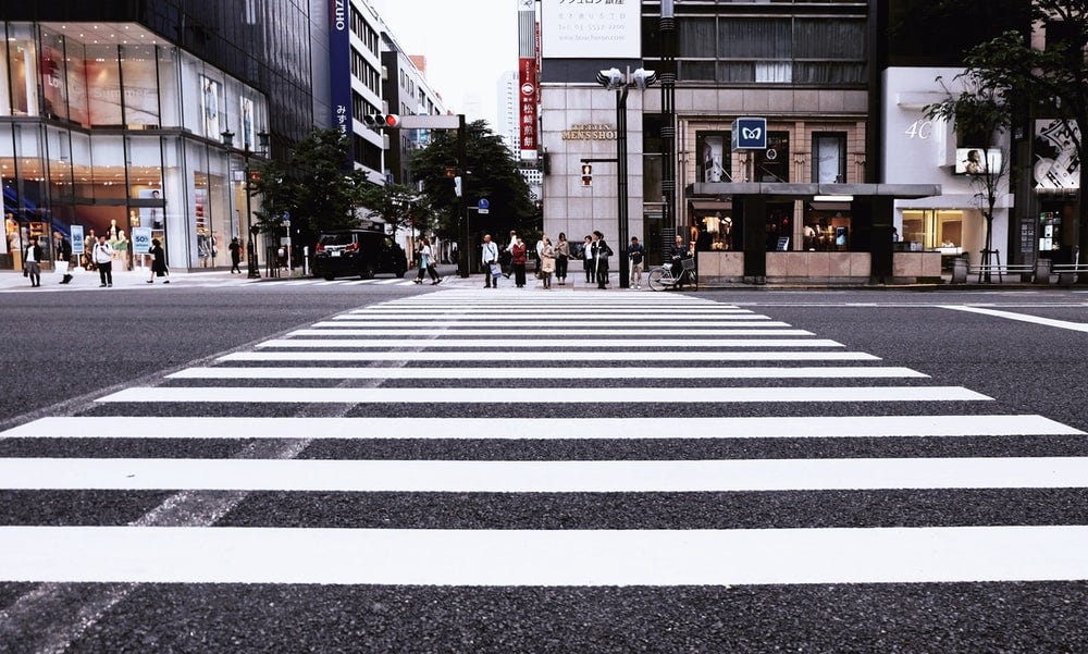 people standing on pedestrian lane people standing on pedestrian lane