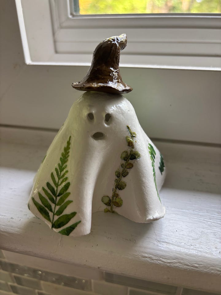 gallery of four clay ghosts decorated for Halloween