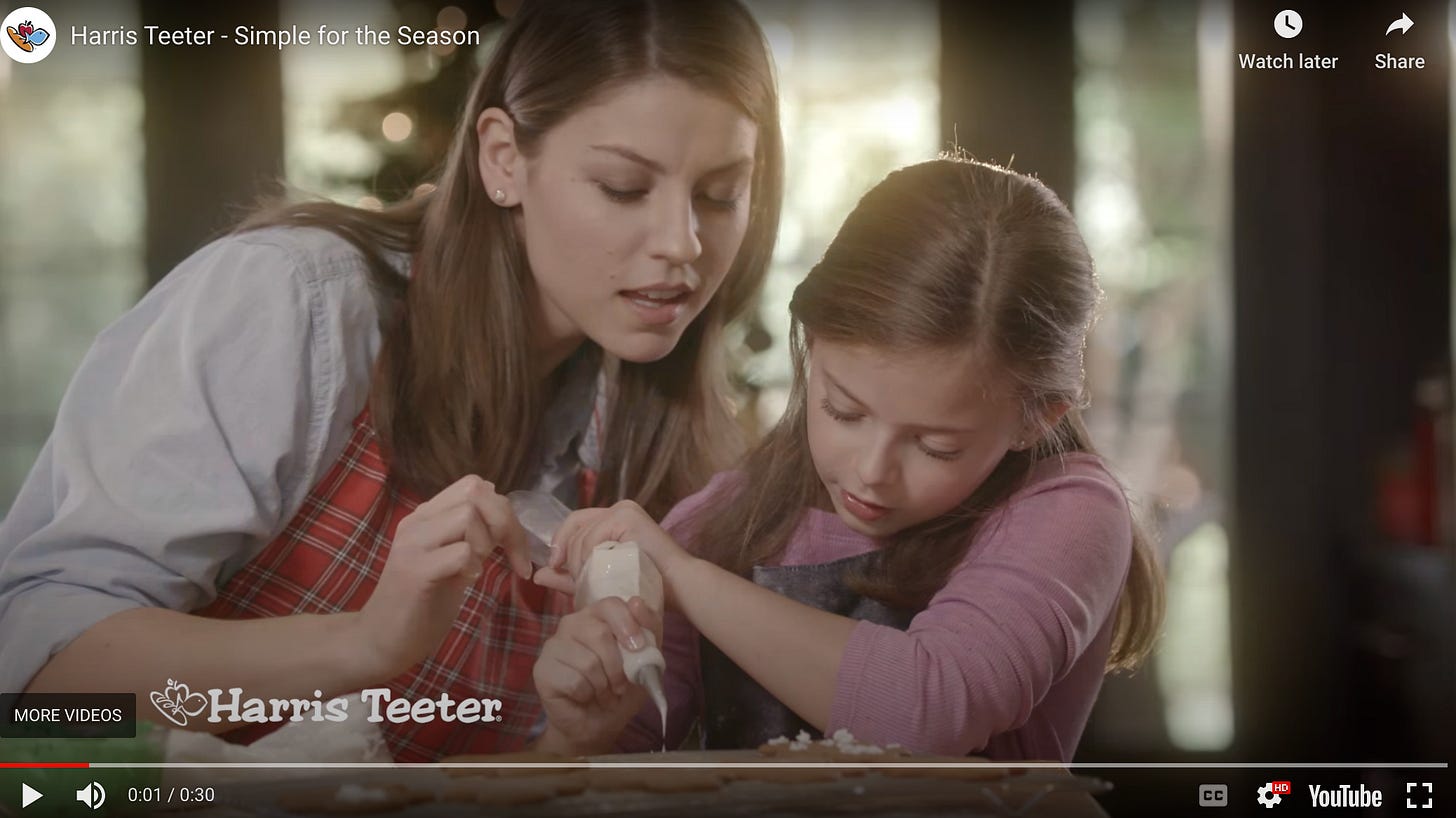 Screenshot of Spurgeon in a commercial helping a young girl pipe icing.