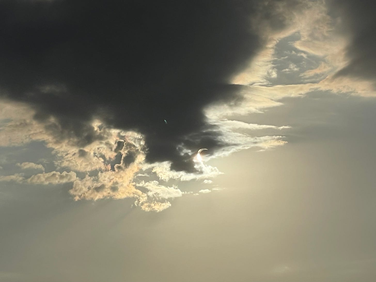 solar eclipse behind a cloud