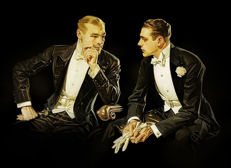 This may contain: two men in tuxedos sitting next to each other