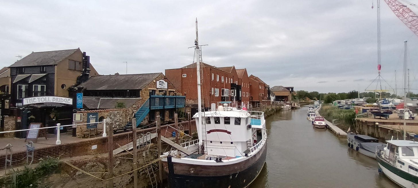 The River Stour at Sandwich, several large boats tied up along the river